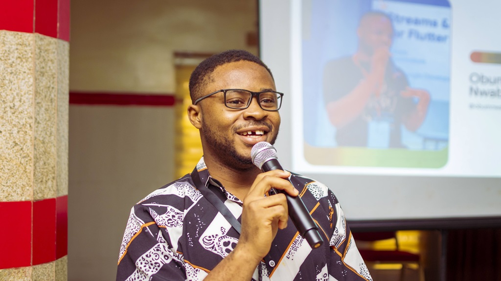 Obum speaking on stage